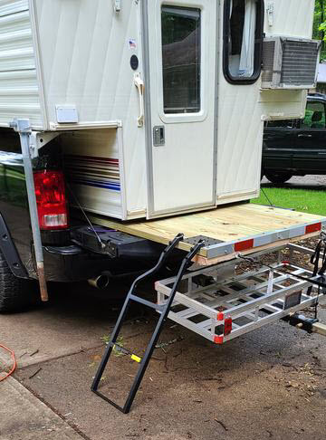Ladder leading from truck camper to ground